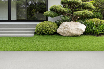 Elegant modern landscaping featuring a manicured lawn and decorative stones in a serene setting