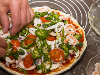 Preparing seafood homemade pizza. close up.