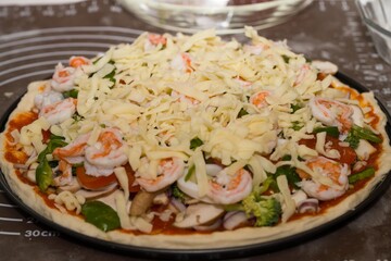 Preparing seafood homemade pizza. close up.