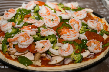 Preparing seafood homemade pizza. close up.