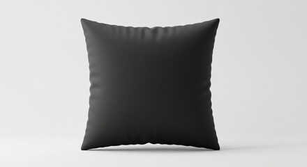 A black square pillow with a smooth texture is set against a plain light background, creating a modern, minimalist, and elegant look.