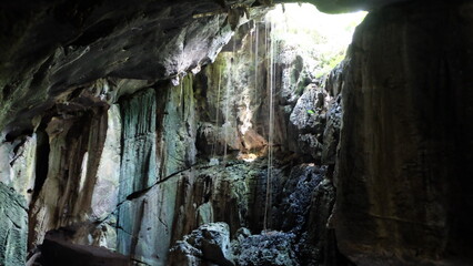 A cave with light shining through.