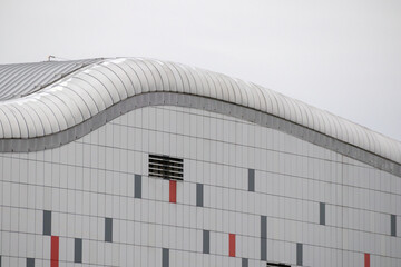 
a large building with modern architecture. The building is made of glass and metal and has an...