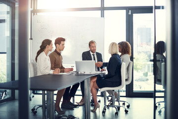 Business people, laptop and handshake in office for deal, sales agreement and corporate collaboration. Investors, tech and shaking hands in agency for new partnership, opportunity and team commitment