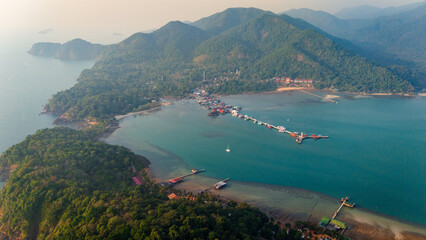 Aerial Ko Chang paradisaical Island in Thailand, white sand beach, sea around lush green mountains
