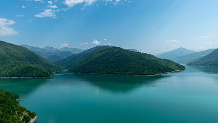 beautiful landscape with a small mountain and a bright green lake
