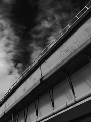 Highway overpass with cloudy sky in black and white tone.
