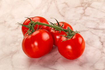Ripe fresh tomato on the branch