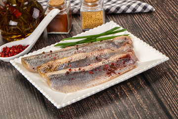 Salted marinated herring fillet with spices