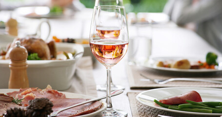 Wine glass, dinner and table with food at restaurant party, social event and celebration at gathering. Alcohol drink, catering service and meal on plate, meat and vegetables for lunch or fine dining