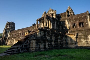 Fototapeta premium Angkor Wat temple in Cambodia under a clear blue sky.