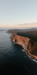 Aerial of coastal cliffs at golden sunset dramatic landscape imagery wide angle view
