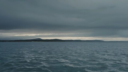 a large body of water under a cloudy sky