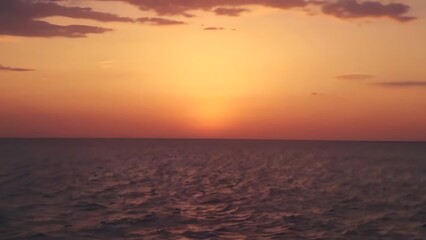 Naklejka premium the sun is setting over a large body of water