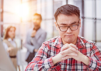 A man sits at the table with folded arms.