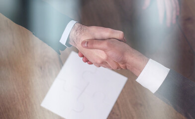 top view of business people shaking hands during meeting