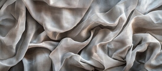 Obraz premium Gray silk fabric folded and wrinkled texture with soft sheen and natural flow Copy Space
