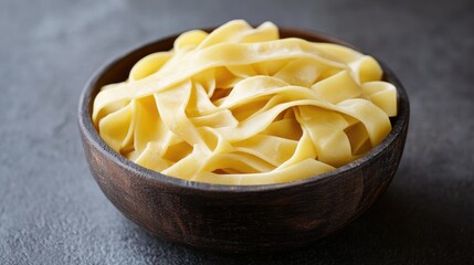 Freshly Made Tagliatelle Pasta in a Rustic Wooden Bowl Ready for Gourmet Dishes