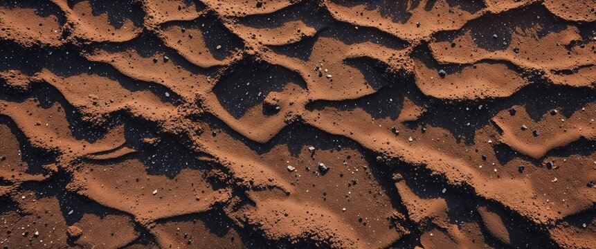 Smoky umber lava formed sand with speckled mineral deposits background