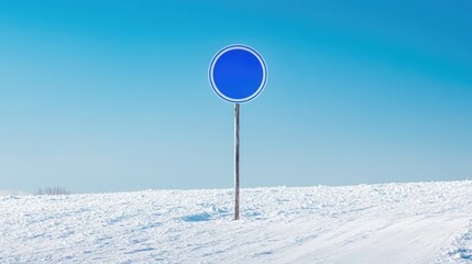 Blank blue speed limit sign on a snow-covered road against a clear blue sky ideal for textual overlays or transportation-related content
