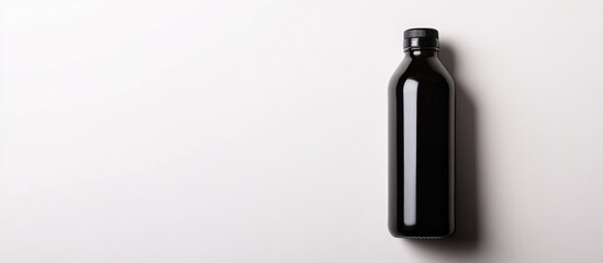 Black water bottle on white background with ample copyspace for branding or text placement in advertising design concepts
