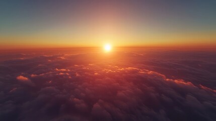Stunning aerial view of a sunrise above the clouds with vibrant colors and empty space for text or branding elements on the horizon