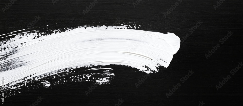 Poster white paint brush stroke on black canvas creating a blank space for text or design elements for arti