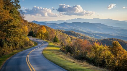 Winding Scenic Mountain Road Surrounded by Vibrant Green Hills and Sun Flare Under Clear Blue Sky