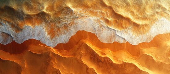 Obraz premium Aerial view of ocean waves crashing on sandy beach with golden and white textures Copy Space