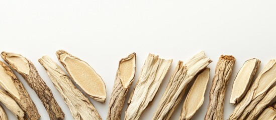 Dried medicinal herb slices arranged on white background with copy space for text placement