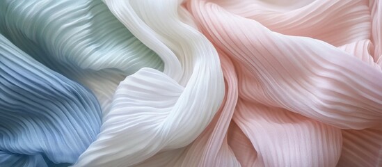 Colorful pleated fabric in blue, white, and pink tones with texture detail and Copy Space for text inclusion.