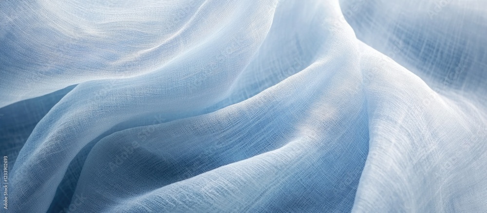 Poster light blue sheer fabric texture with soft waves and folds suitable for background design and copy sp
