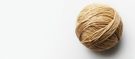 Brown yarn ball on white background with ample copy space for text placement