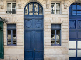 Classical high wooden front door blue wood of street restored house entrance dark classic gate