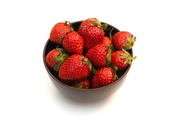 A bowl filled with fresh, ripe strawberries placed against a clean white background. 