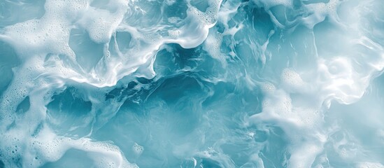 Obraz premium Aerial view of turbulent ocean water in shades of blue and white with foamy waves and Copy Space for text placement