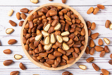 roasted pine nuts food on wooden table.