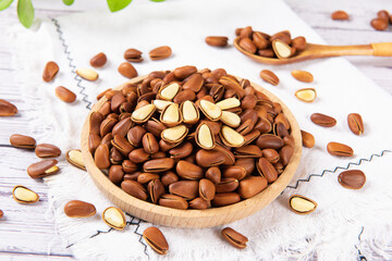 roasted pine nuts food on wooden table.