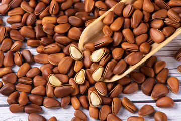 roasted pine nuts food on wooden table.