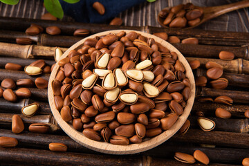 roasted pine nuts food on wooden table.