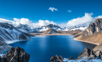 A magnificent natural landscape with a meandering river whose water appears turbid yellow. The river is flanked by red hills
