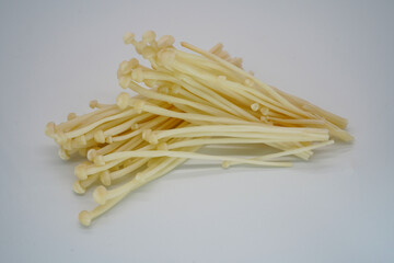 Golden Needle Mushrooms are white-yellow in color, have small heads and long stems.