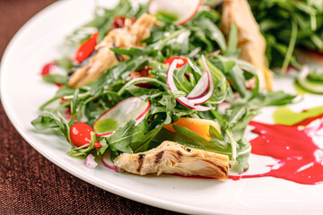 Portion of gourmet fresh salad with artichokes and sauce