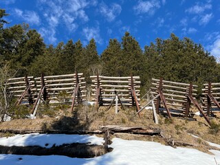 Protection against avalanches in the Swiss Alps mountain range or Wooden fences as protection from snow avalanches and snow drifts, Engelberg - Canton of Obwalden, Switzerland (Kanton Obwald, Schweiz)