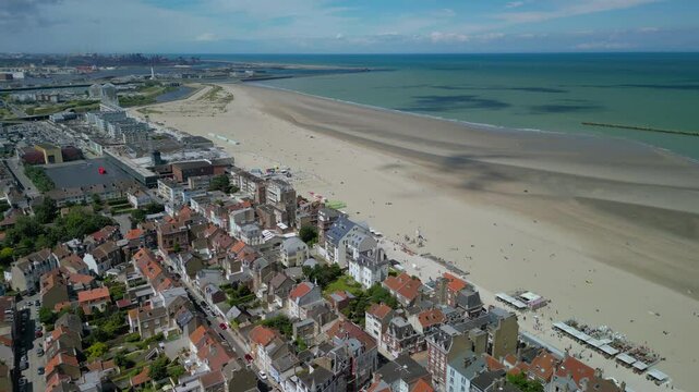 The drone aerial footage of beach and the city of Dunkirk, France. Dunkirk is a commune in the department of Nord in northern France.	
