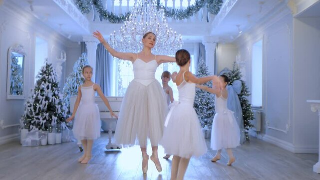 Group of young girls are dancing in a ballroom with a piano in the background. The girls are wearing white dresses and are performing a ballet routine. Scene is elegant and graceful