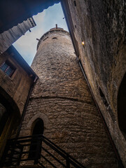 Trento, Italy: View of Castello del Buonconsiglio courtyard framed by stone walls with the Alps in...