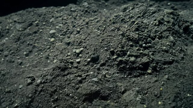 Macro camera movement across compacted clay soil with dramatic lighting emphasizing hard, angular peds and lack of pore space, strong contrasts highlight density