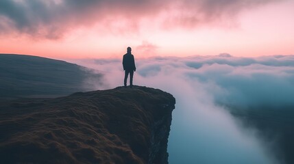 Solitary Figure on Mountaintop at Sunrise Above Cloudscape Peaceful Scene