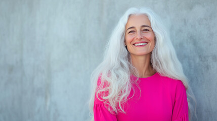 Fototapeta premium With long flowing white hair, a young woman smiles brightly, her vibrant energy amplified by the bold pink dress she wears. The combination of her unique hair color and the eye-cat